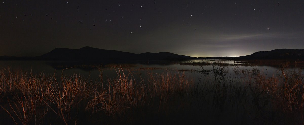 Night sky over a still lake